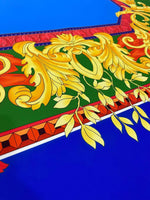 Blue baroque silky crepe fabric with intricate gold and red ornamental pattern
