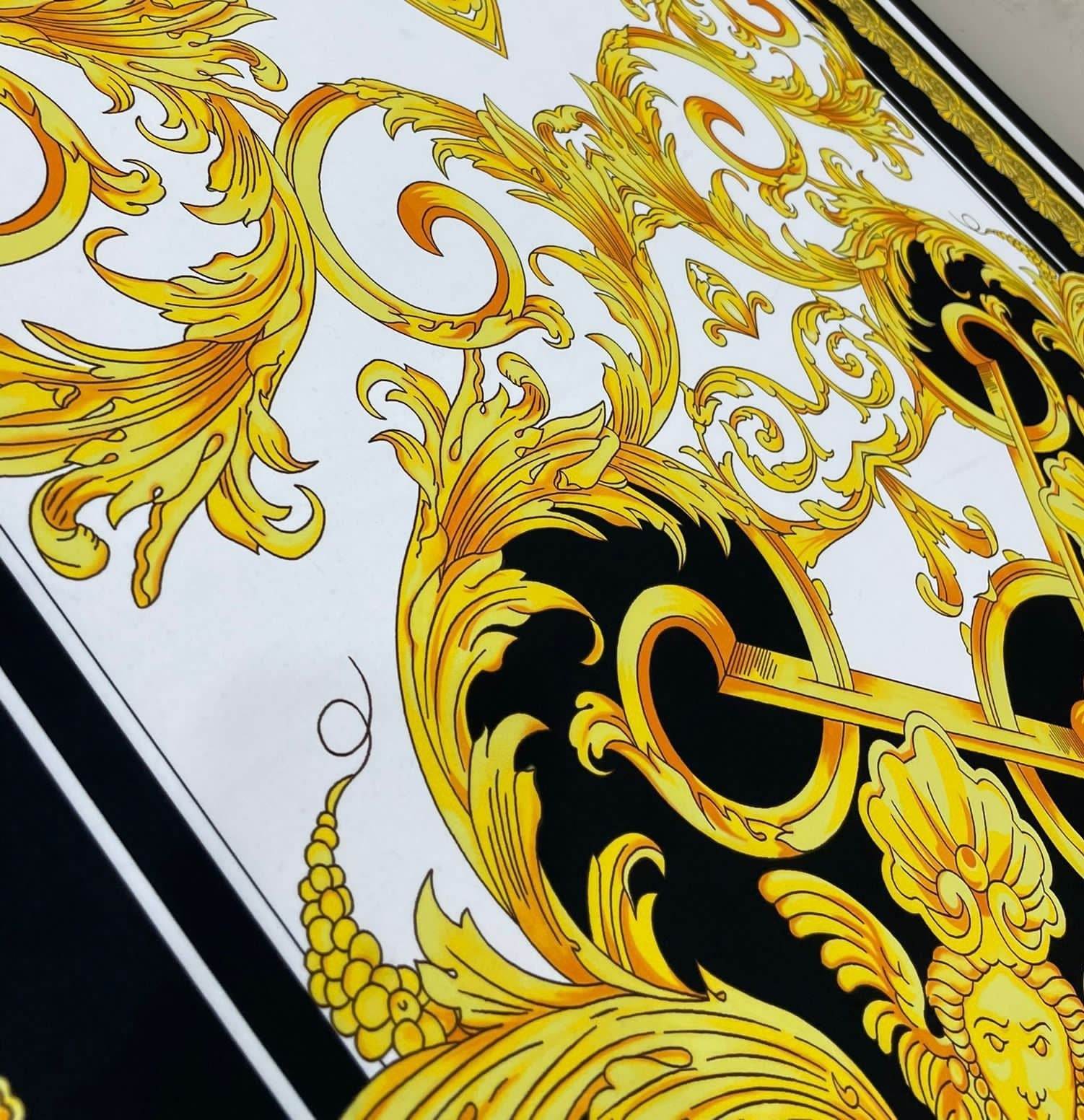 Baroque silky crepe fabric with elegant gold and black ornate pattern on white background