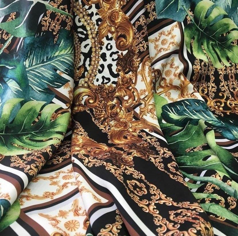 Baroque Tropical Green fabric with gold ornate designs and lush green tropical leaves on black and white background