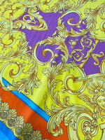 Baroque pattern silky crepe fabric with vibrant yellow, purple, blue, and orange colors and intricate ornamental design