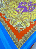 Baroque pattern silky crepe fabric in vibrant orange, blue, and gold ornate design panel