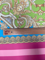 Baroque pink silky crepe fabric panel with ornate gold and green baroque design and pink striped border, 150cm width with ruler for scale
