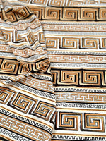 Beige brown silky crepe fabric with geometric Greek key pattern and smooth drape