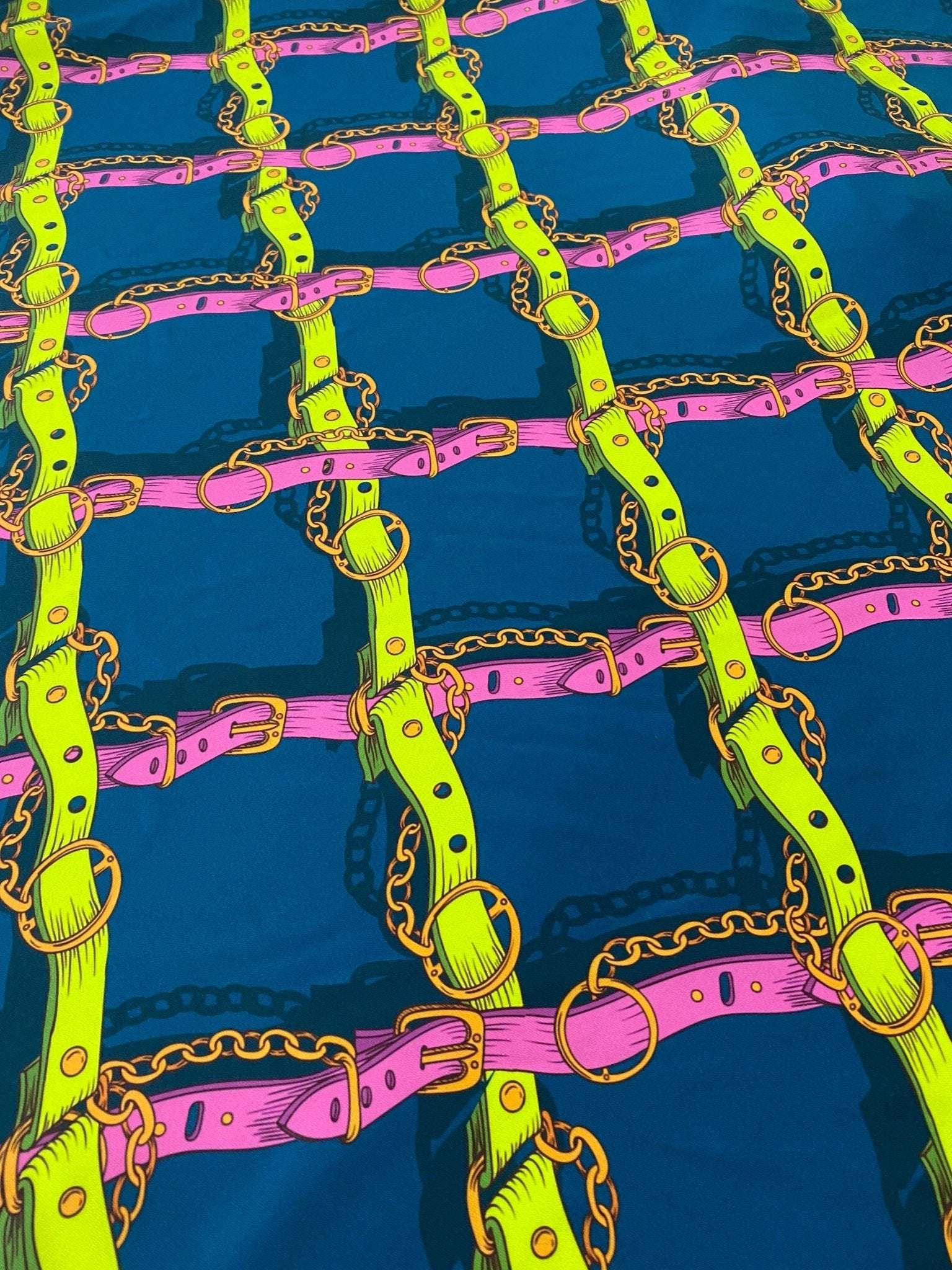 Pink and yellow chain pattern fabric with vibrant belt and ring design on dark blue background