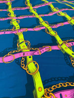Pink and yellow chain pattern fabric on blue background with belt and ring details