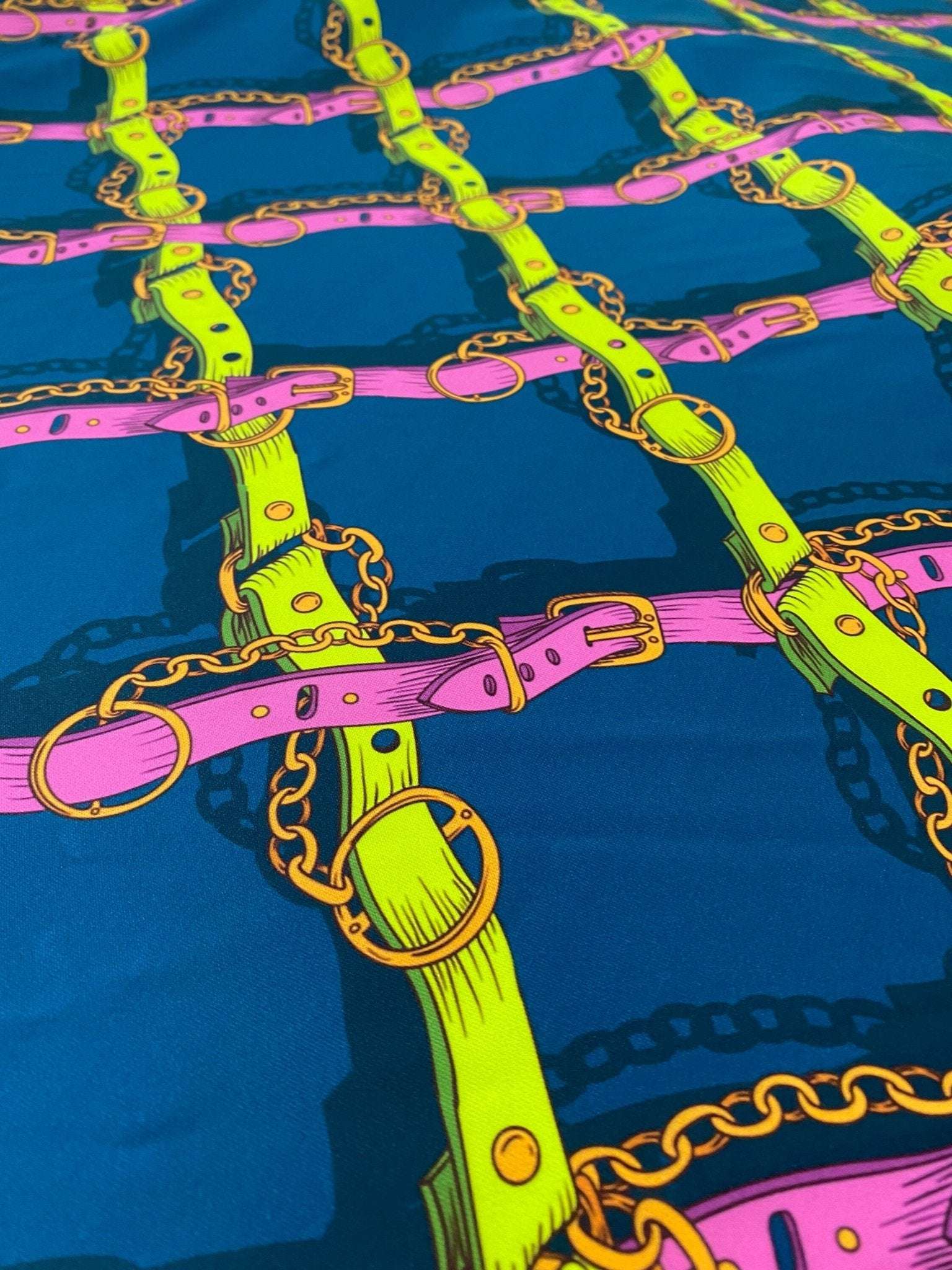 Pink and yellow chain pattern fabric on blue background with belt and ring details
