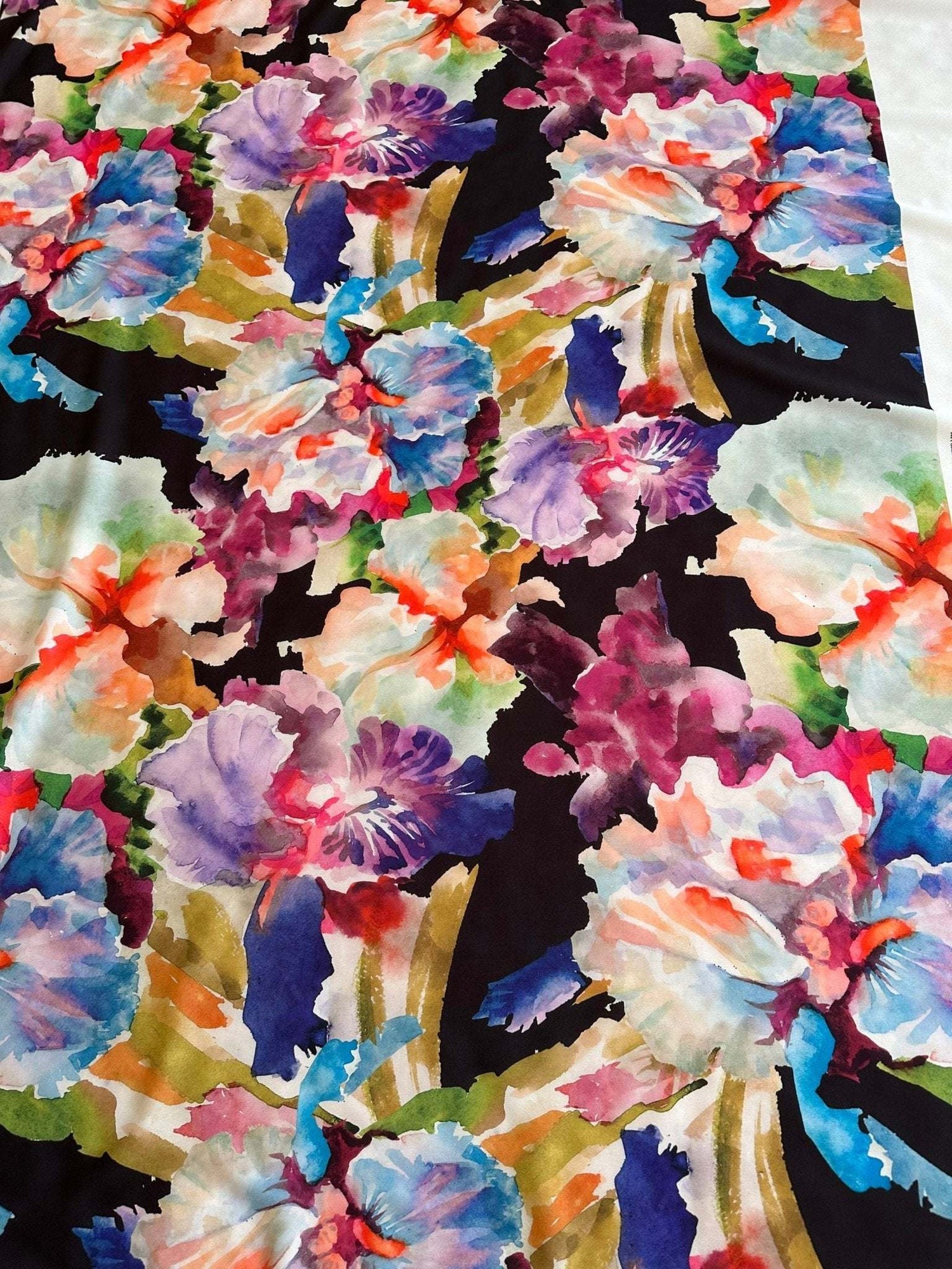 Watercolor floral crepe fabric with large colorful flowers on a black background