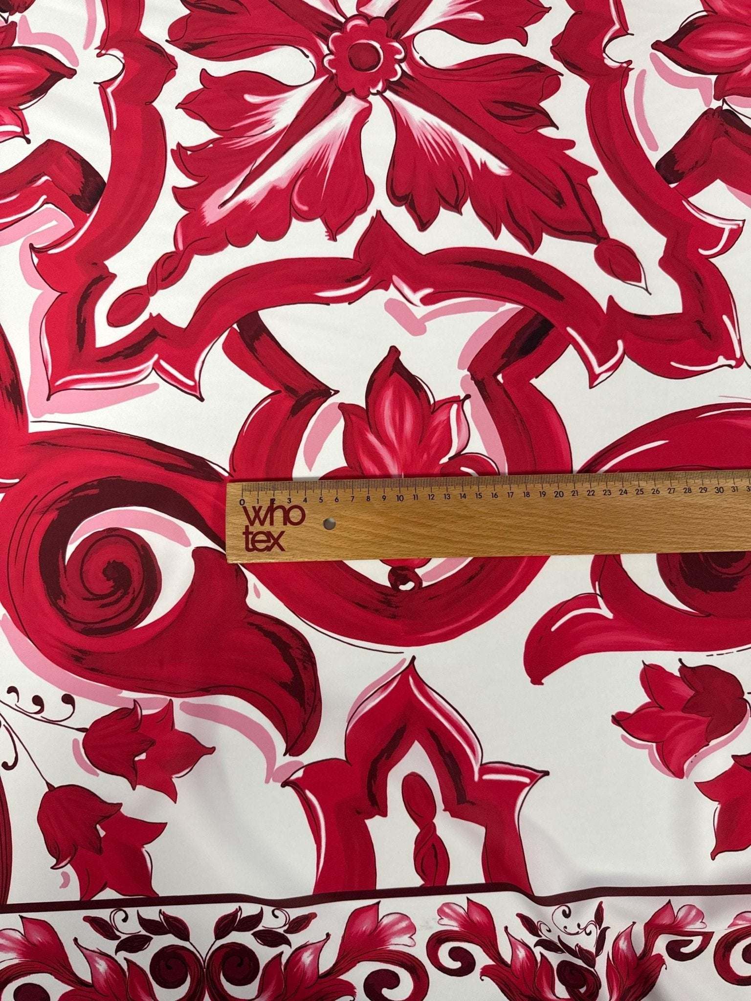 Red Big Majolica Pattern Fabric with vibrant magenta motifs on white background, fabric width 150cm, ruler for scale