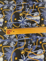 Black and blue tropical fabric with gold chain pattern and tropical leaves design