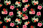 Black fabric with vibrant rose pattern in pink, red, and white flowers with green leaves digital print