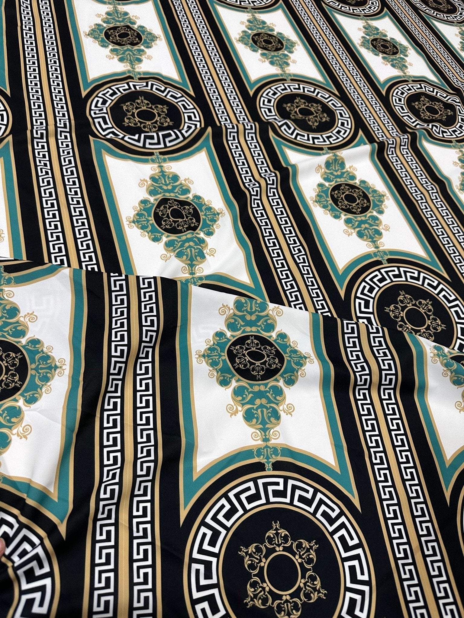 Greek Key Pattern Fabric with black, gold, and teal ornate geometric design on white background
