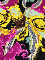 Black pink fabric with Greek key print and ornate yellow floral patterns on black background