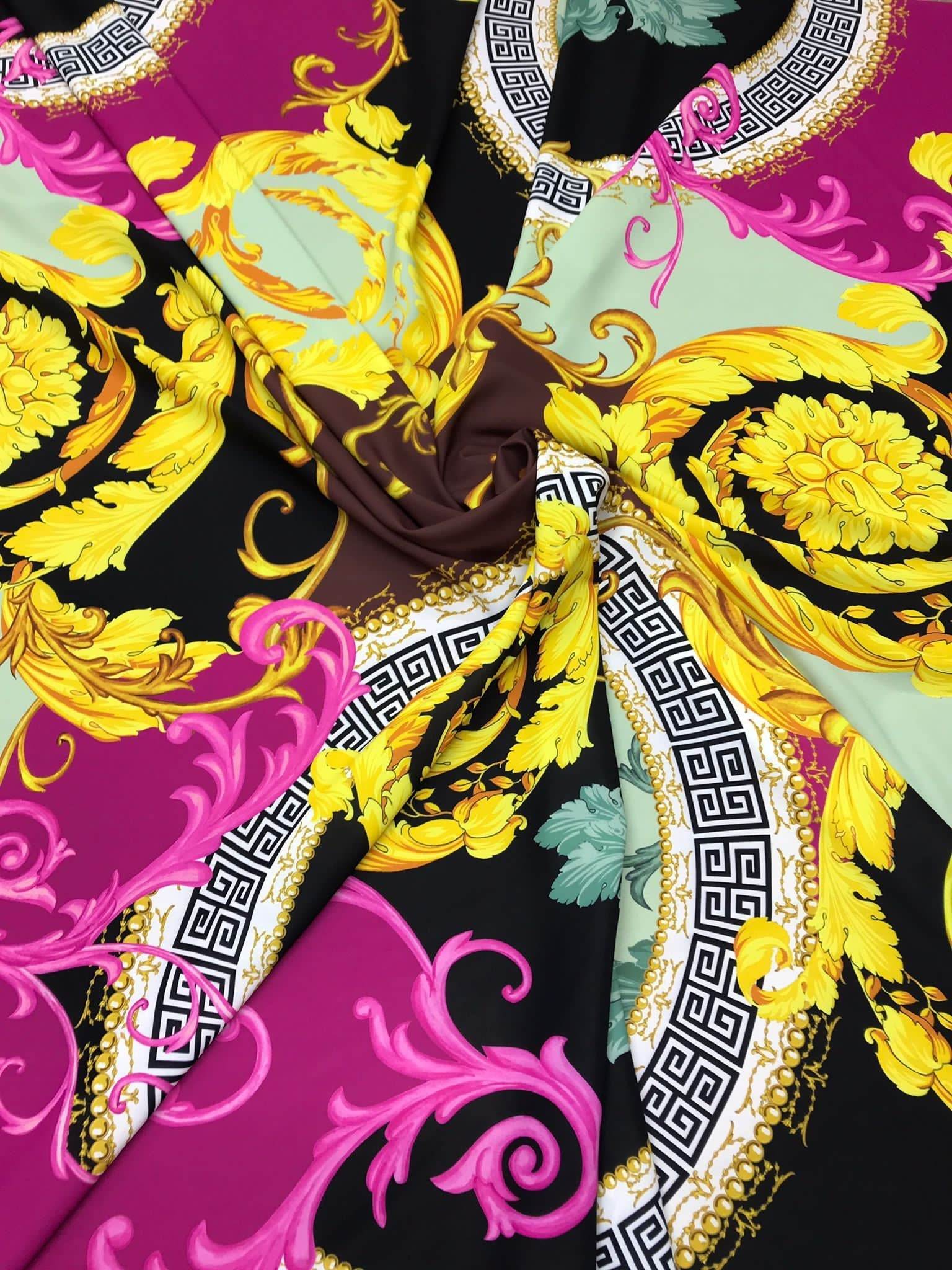 Black pink fabric with Greek key print and ornate yellow floral patterns on black background