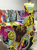 Black pink fabric with Greek key print design displayed on a mannequin in a fabric store