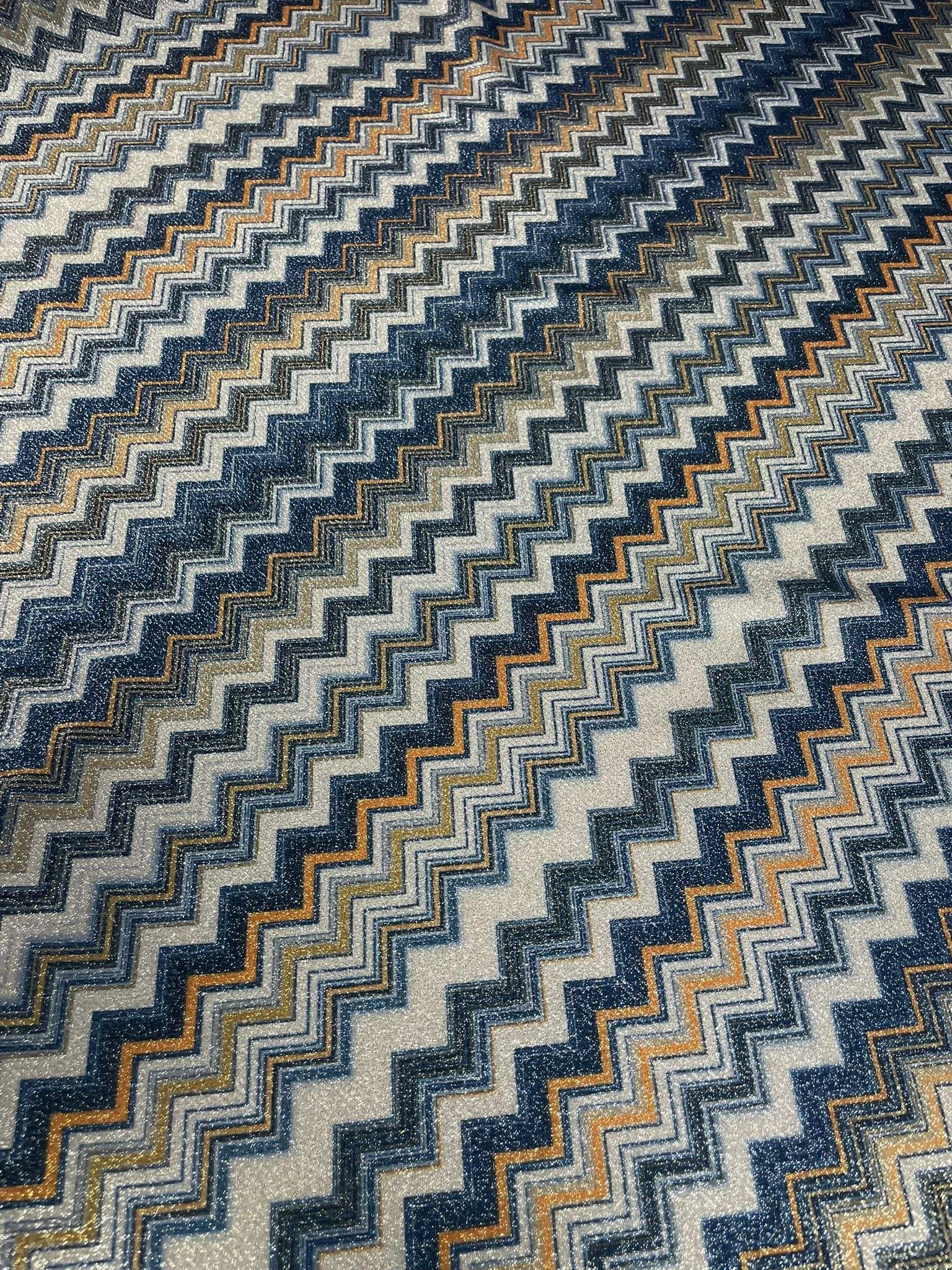 Gold Lurex striped glitter fabric with blue and orange zigzag pattern and 4-way stretch polyester blend