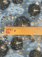 Blue grey fabric with dandelion print and floral accents, soft and durable textile for sewing projects