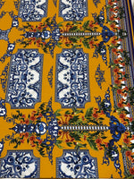 Elegant mustard yellow Baroque floral fabric with intricate blue and orange floral patterns for upholstery and garments