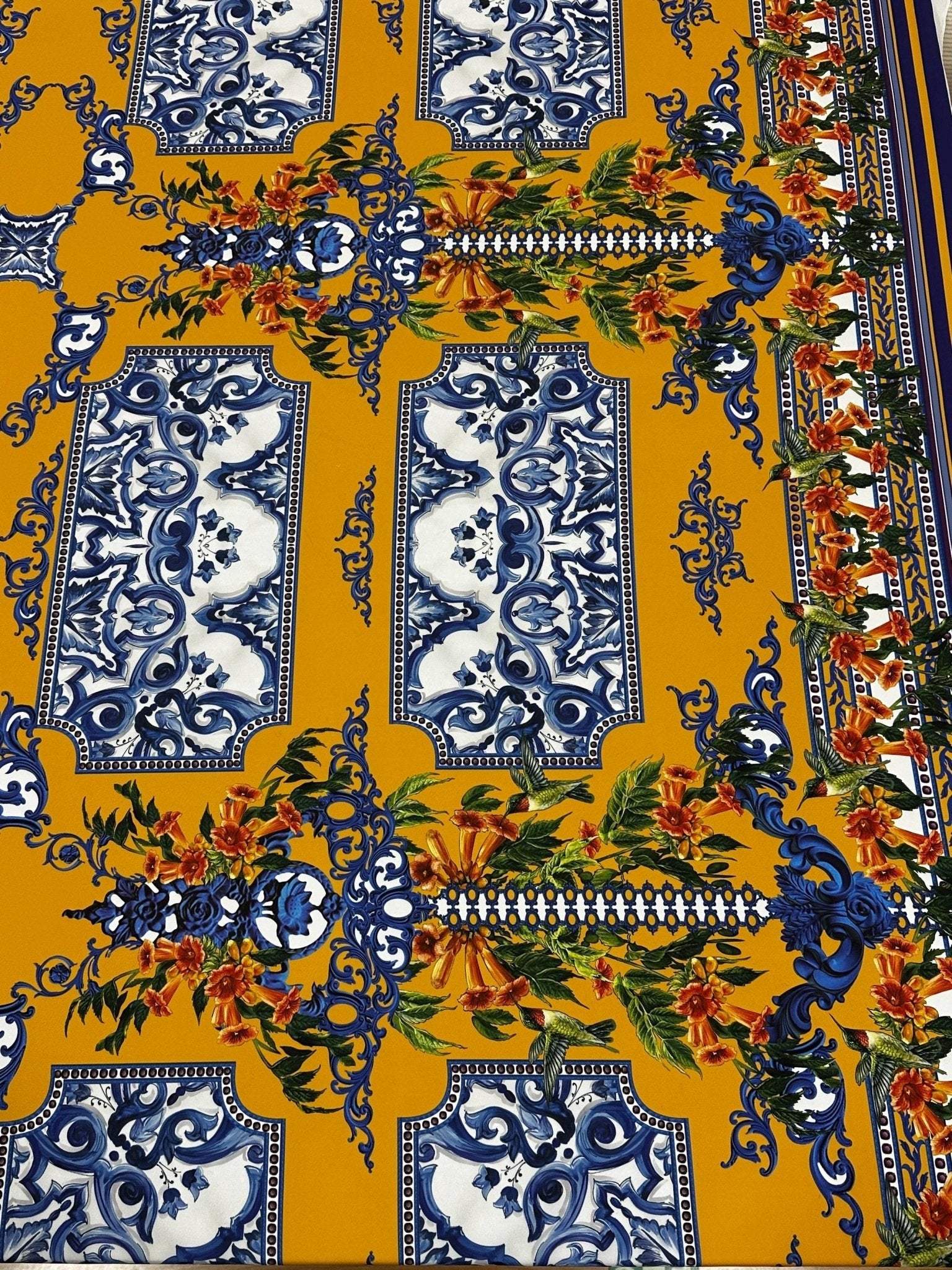 Elegant mustard yellow Baroque floral fabric with intricate blue and orange floral patterns for upholstery and garments