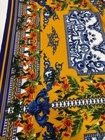 Elegant mustard yellow Baroque floral fabric featuring intricate blue and orange floral patterns for upholstery and garments