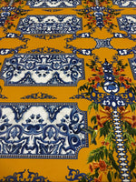elegant mustard yellow baroque floral fabric with intricate blue and white patterns and detailed orange floral accents
