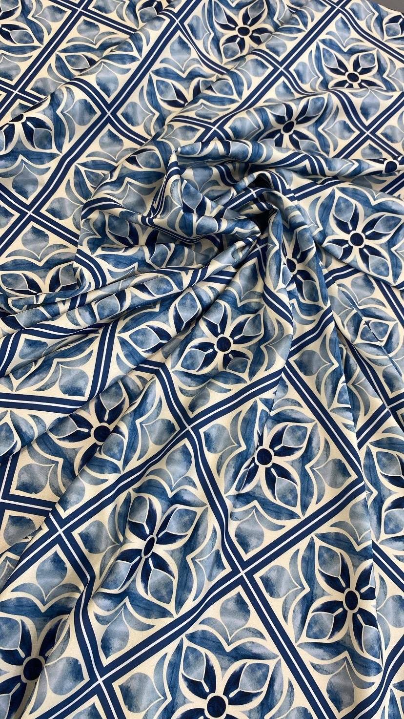 Blue Mediterranean tile pattern fabric with intricate floral and geometric designs in various shades of blue and white.