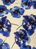 Bold blue watercolor floral fabric with vibrant blue flowers on a white background