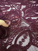 Bordeaux floral pattern lace fabric close-up showing intricate floral design and texture suitable for fashion and crafts