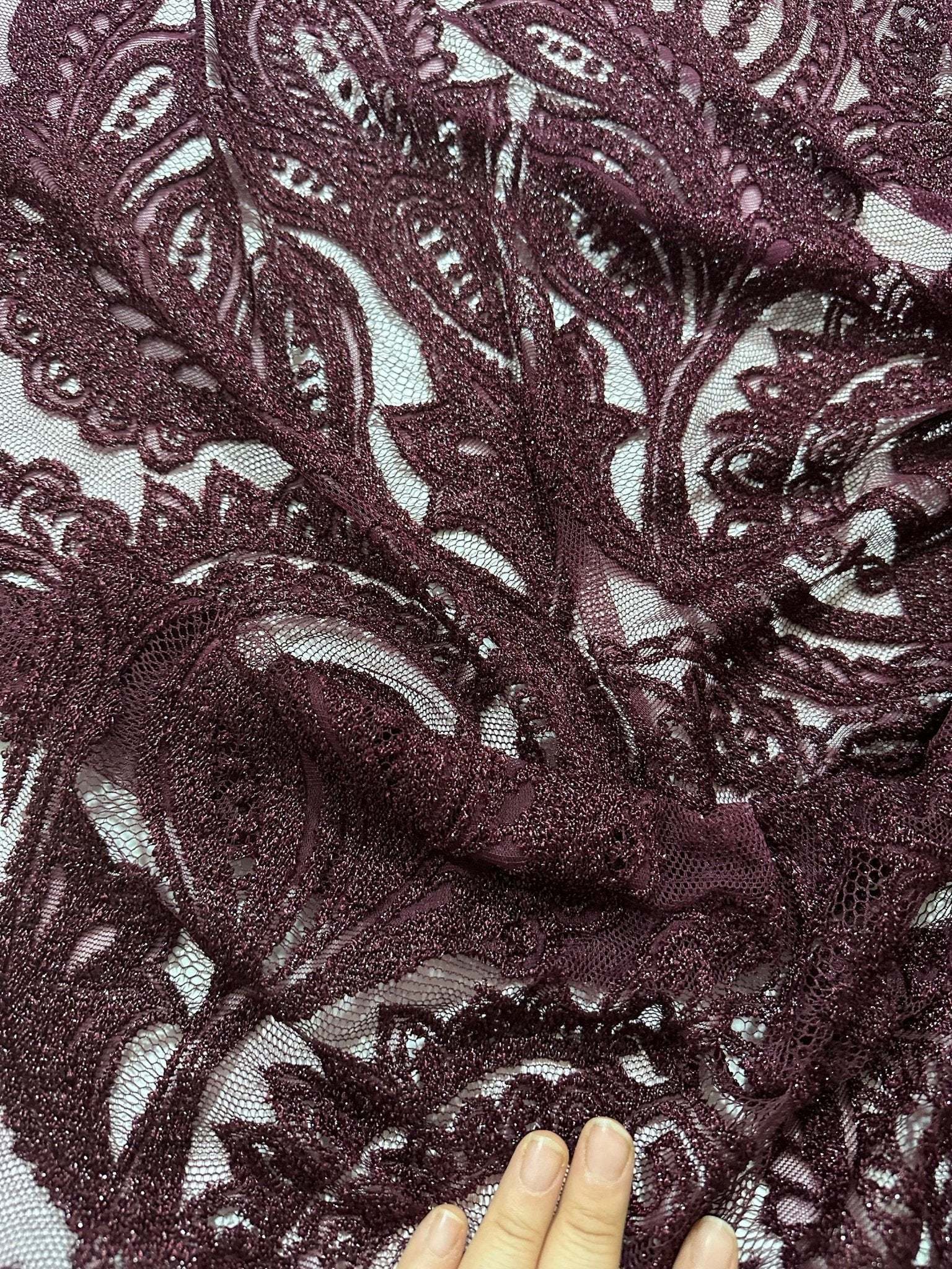 Bordeaux floral pattern lace fabric with intricate floral design in deep burgundy color, suitable for clothing and crafts.