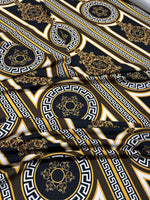 Brown silky crepe fabric with intricate Greek key pattern and gold accents, smooth and elegant texture