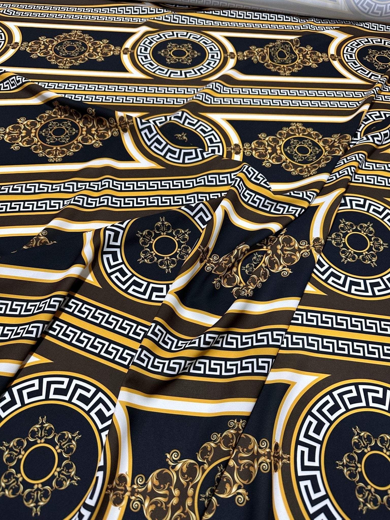 Brown silky crepe fabric with Greek key pattern and elegant gold and black design