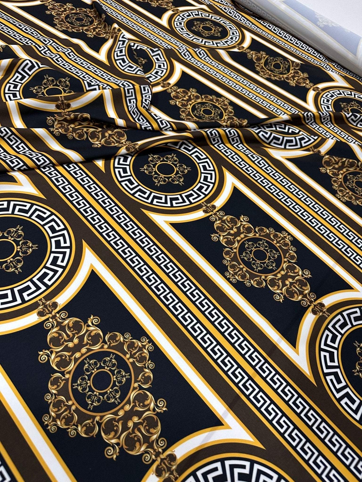 Brown silky crepe fabric with elegant Greek key pattern and intricate gold design