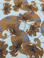 Brown floral print fabric on light blue background with purple and tan accents