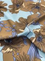 Brown floral print fabric with light blue background and purple leaf accents, 150cm width