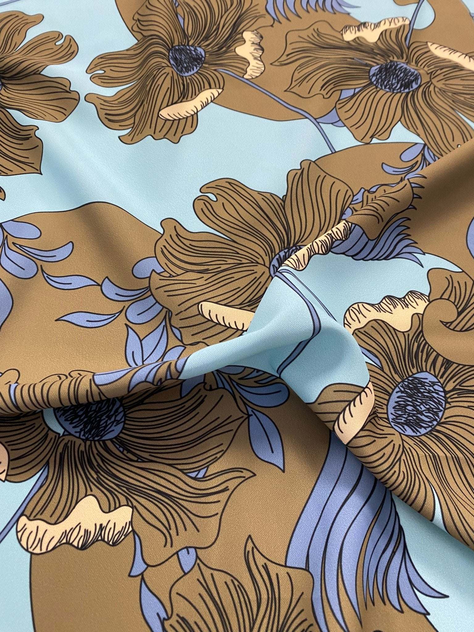 Brown floral print fabric with light blue background and purple leaf accents, 150cm width