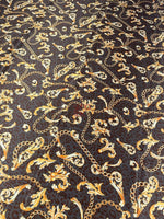 Brown leopard print fabric with gold baroque chain pattern and floral accents.