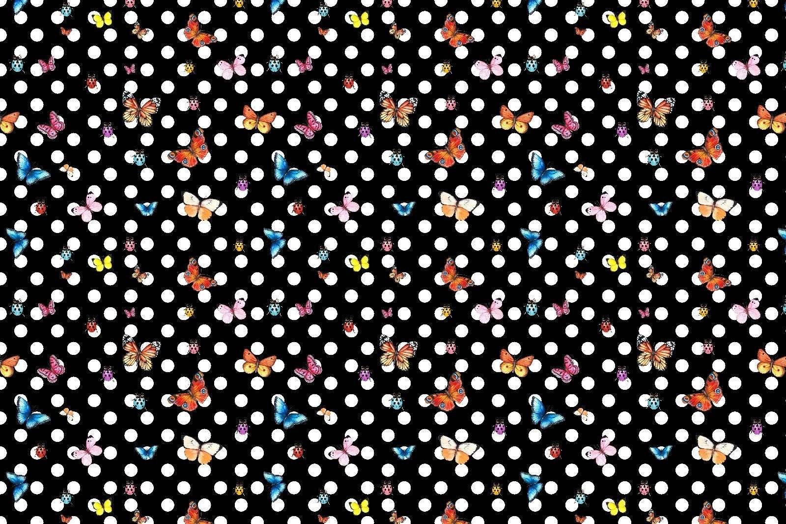 Black fabric with white polka dots and colorful butterfly pattern for sewing projects
