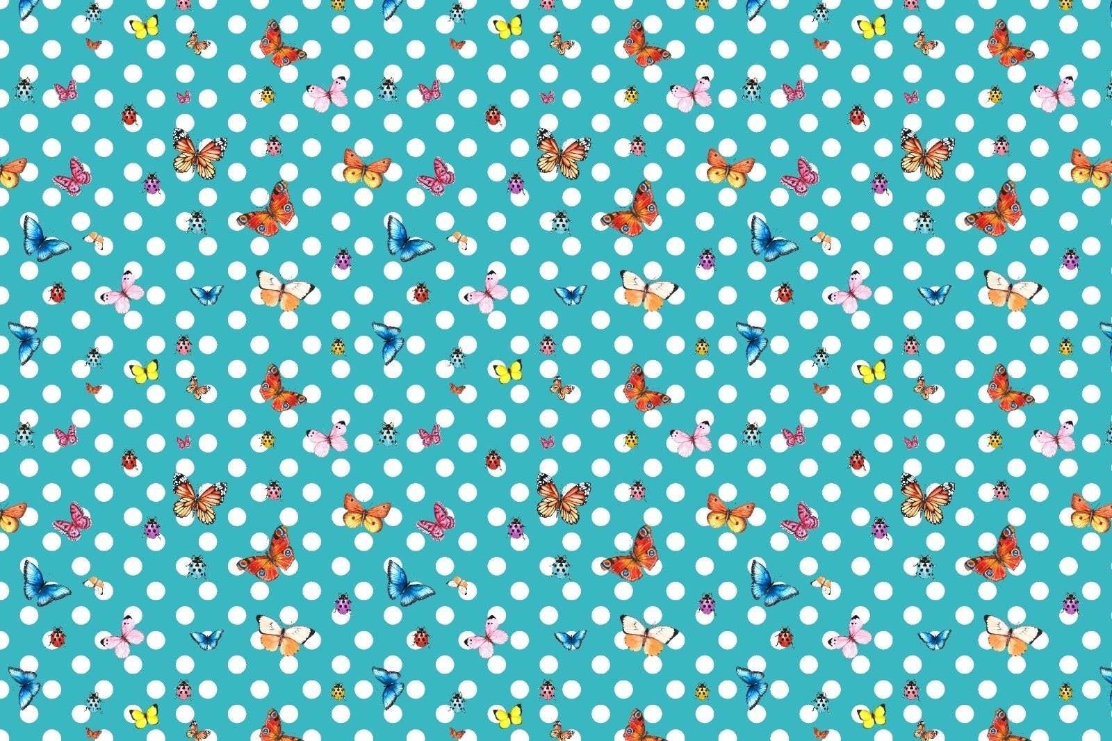 Baby blue fabric with white polka dots and colorful butterfly pattern for sewing projects