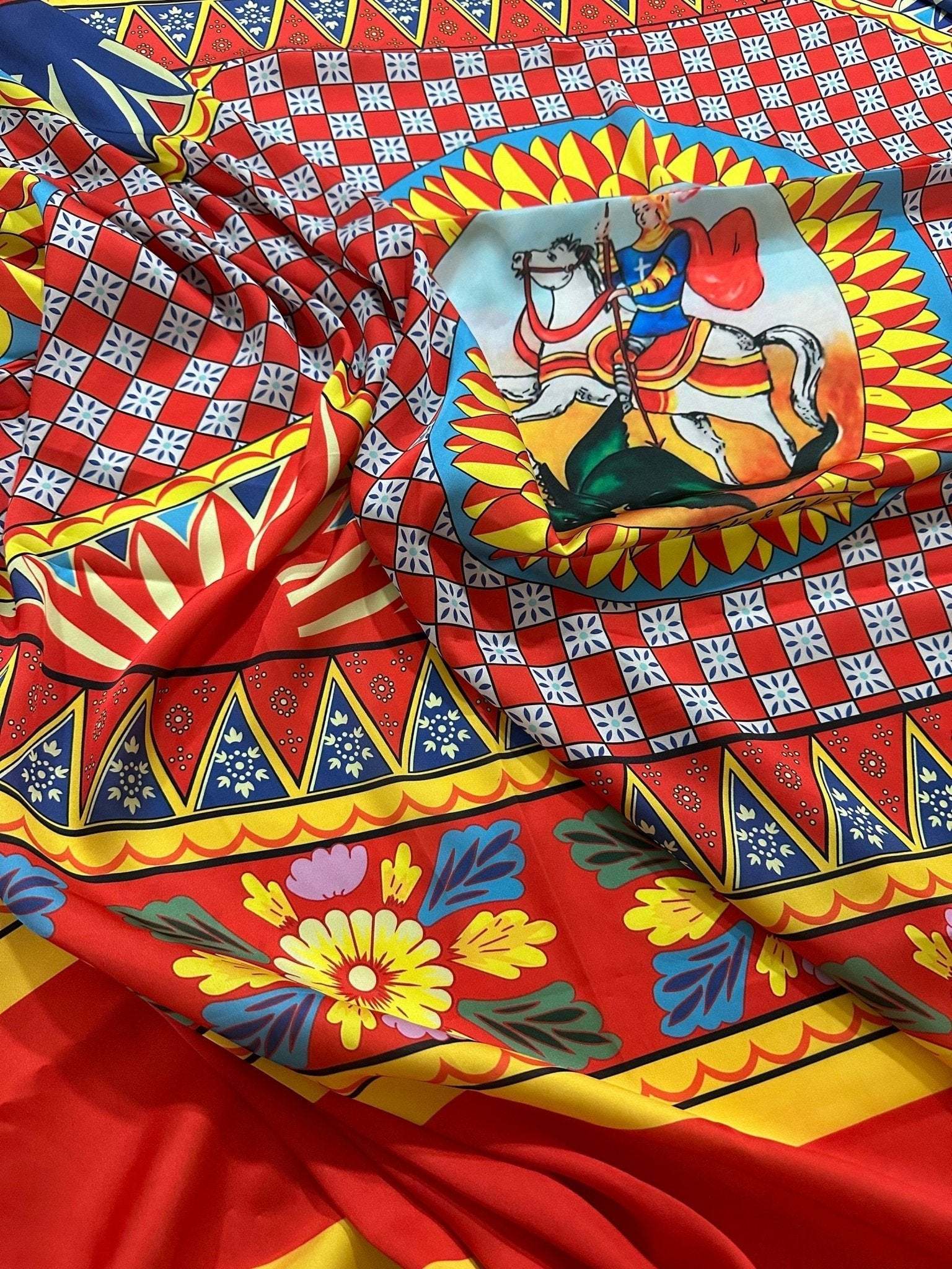 Bright Caretto Scilly designs fabric with vibrant patterns and detailed horseman motif, 150cm width