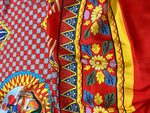 Caretto Scilly designs vibrant patterned fabric with red, yellow, blue, and floral motifs for sewing projects
