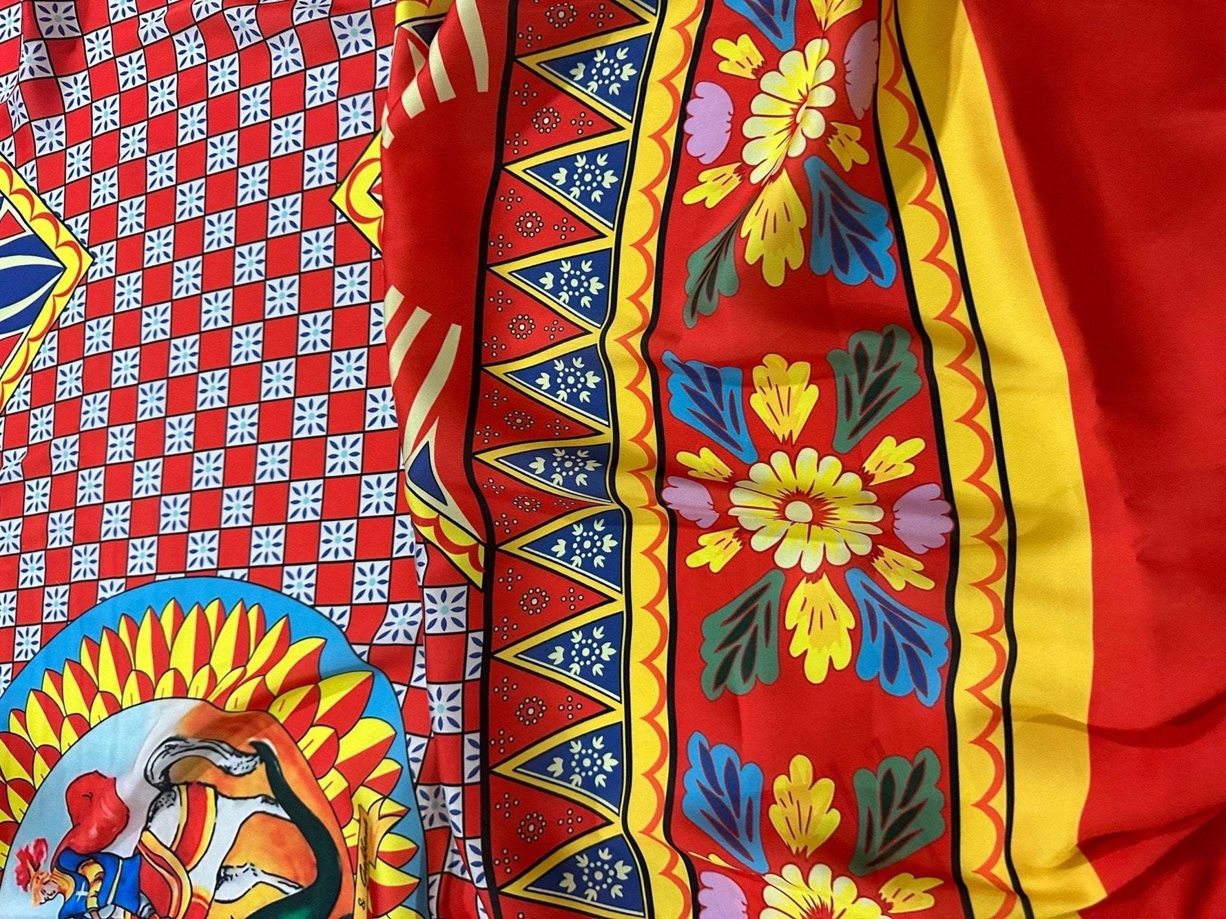 Caretto Scilly designs vibrant patterned fabric with red, yellow, blue, and floral motifs for sewing projects