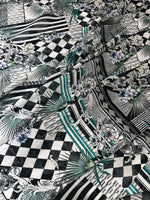 Checkerboard patchwork fabric with black and white squares and floral accents for quilting and crafting projects