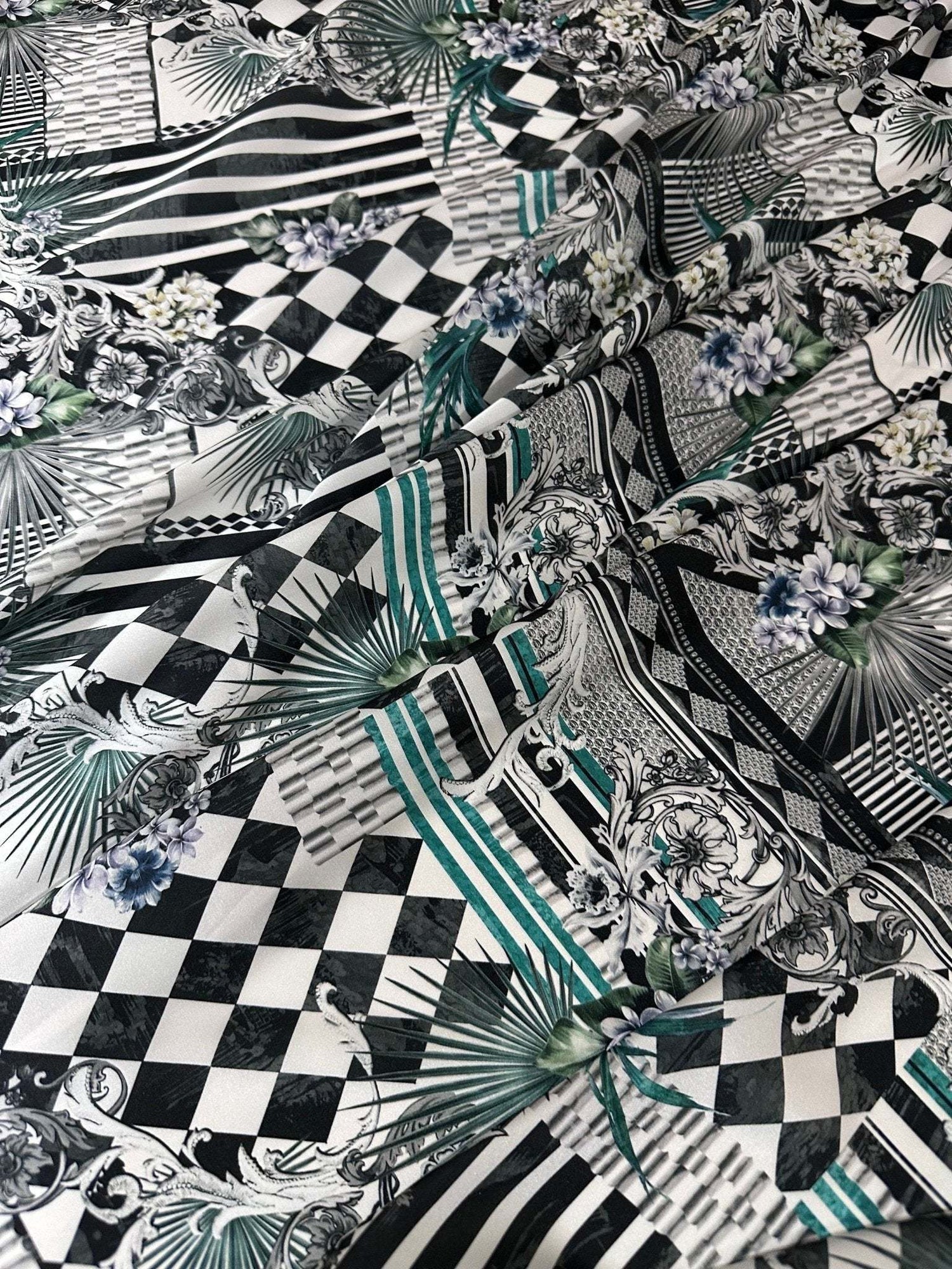 Checkerboard patchwork fabric with black and white squares and floral accents for quilting and crafting projects