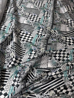 Checkerboard patchwork fabric with black, white, and teal geometric and floral patterns for quilting and crafting