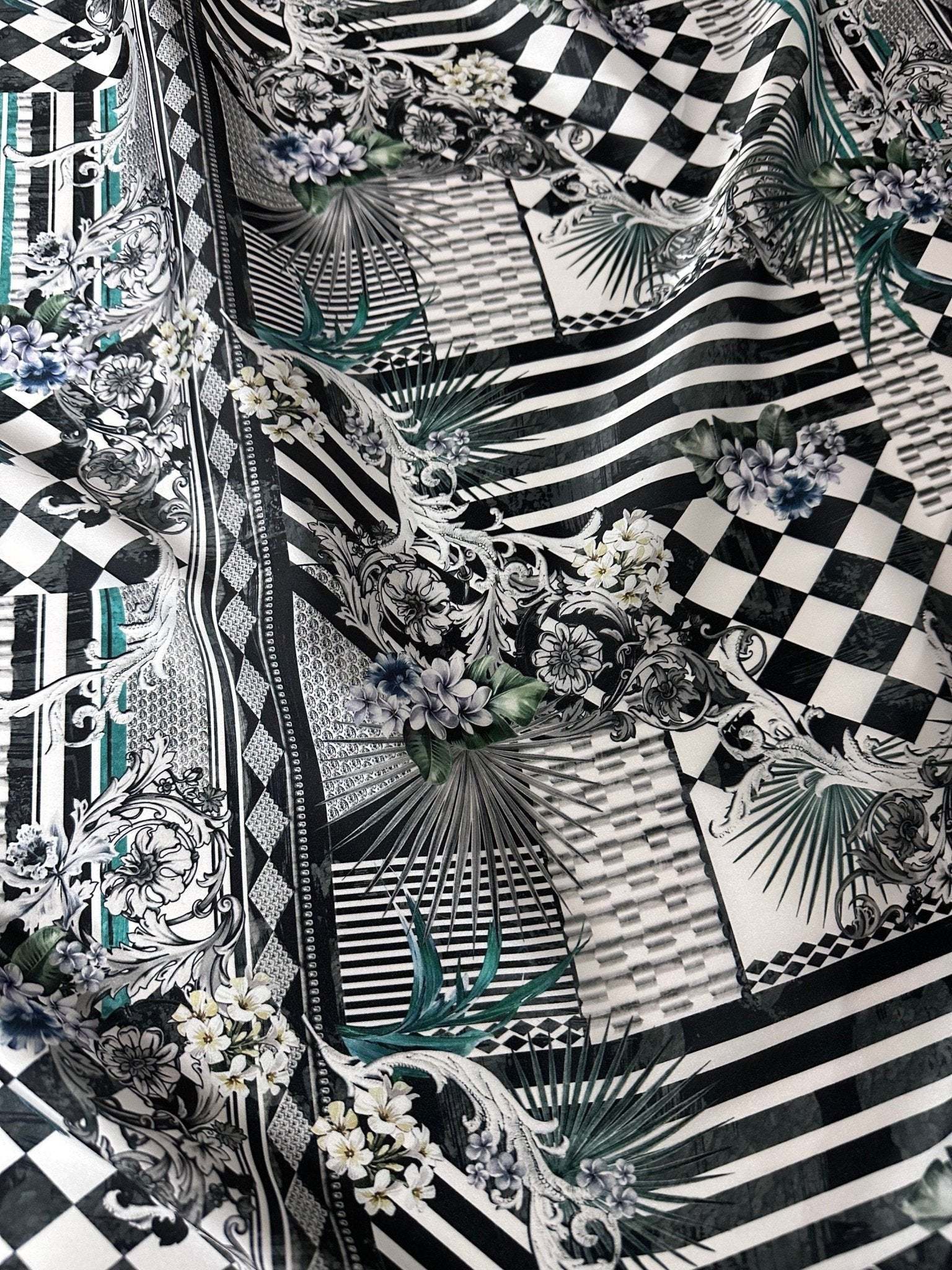 Checkerboard patchwork fabric with black and white geometric patterns and floral accents, 150cm wide, ideal for quilting and crafting projects