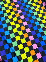 Colorful rainbow checkers print fabric with vibrant squares on a black background, suitable for sewing projects and crafts