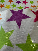 Close-up of colorful stars sequin fabric with 2-way stretch and vibrant star patterns on white background