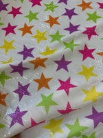 Colorful stars sequin fabric with 2-way stretch on white background for fashion garment designs