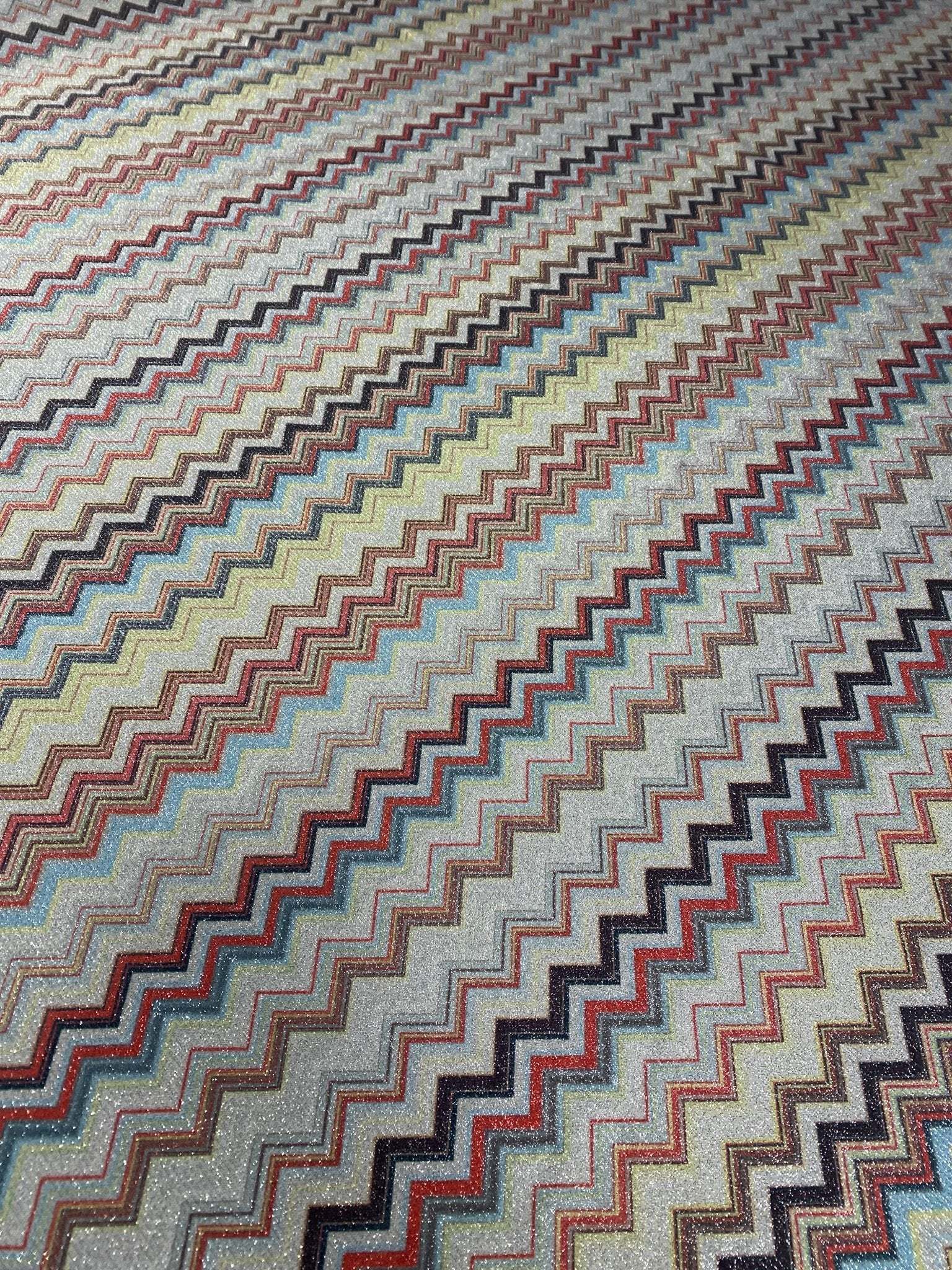 Colorful zigzag pattern metallic fabric with shimmering gold lurex stripes and 4-way stretch polyester blend