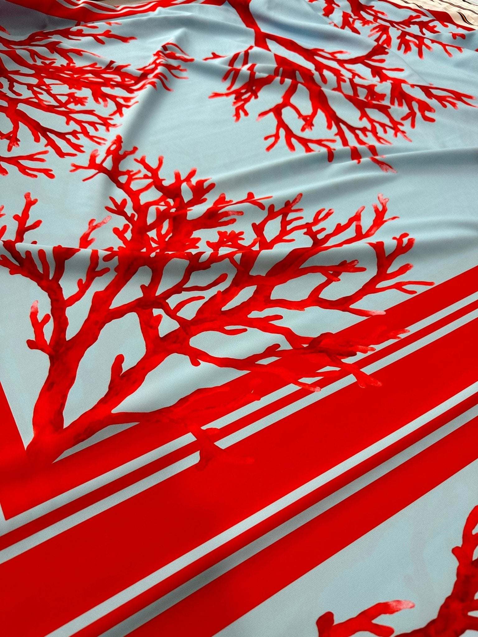 Coral pattern silky crepe fabric in red and blue with coral branch design and striped border