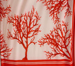 Silky crepe fabric with vibrant red coral pattern on soft pink background, 150cm width